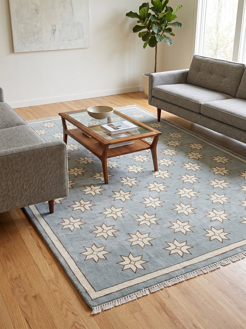 Close-up of cream star pattern on blue handmade wool rug